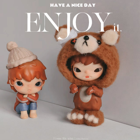 Two small figurines on a light gray background with text 'Have a nice day, ENJOY it.' and 'Relax time'.