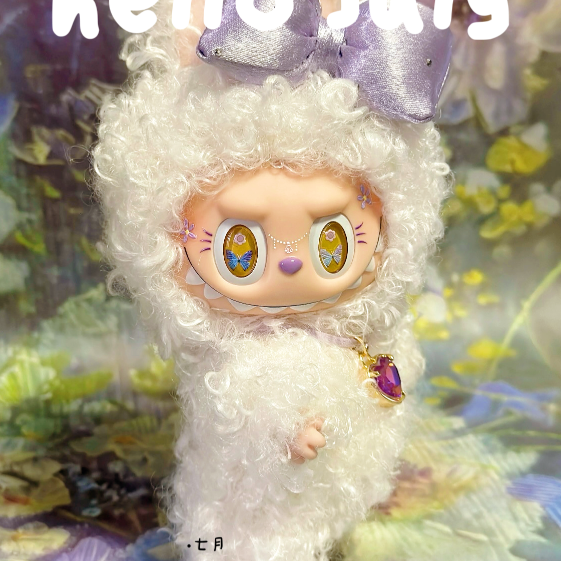 Toy figure with white fur and purple bow, set against a colorful abstract background with 'hello july' text.