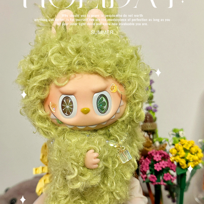 Toy figure with green hair and outfit in a decorative setting with flowers and text.